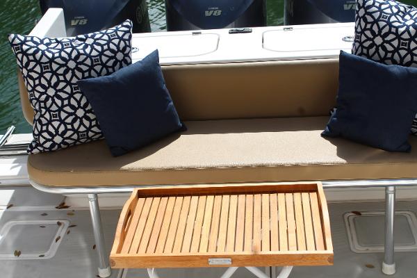 Slide: The Image of Contender 38 Express 2008 boat seating area with cushions and wooden tray. - 29