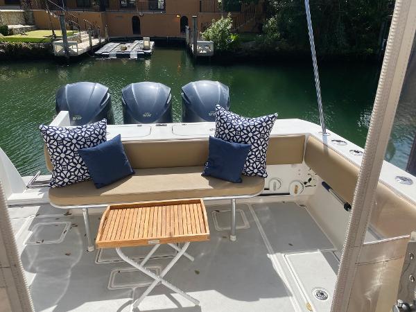 Slide: The Image of 2008 Contender 38 Express boat with cushioned seating and decorative pillows. - 30