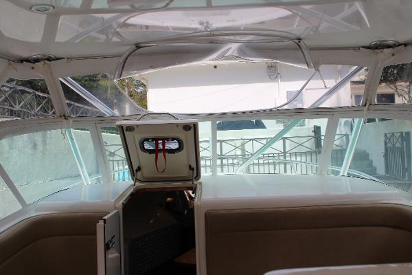 Slide: The Image of 2008 Contender 38 Express boat interior with open cabin door and seating. - 31