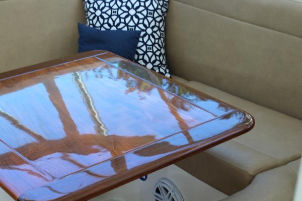 Slide: The Image of Interior seating and table of 2008 Contender 38 Express boat with decorative pillows. - 33