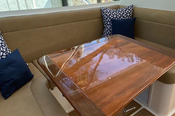 Slide: The Image of 2008 Contender 38 Express boat interior with wooden table and cushioned seating. - 36