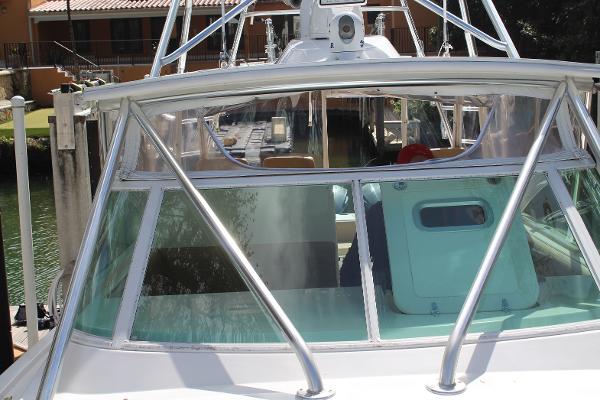 Slide: The Image of 2008 Contender 38 Express boat docked, front view showing windshield and cabin. - 4