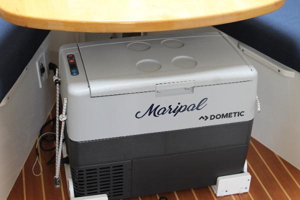 Slide: The Image of Dometic cooler on 2008 Contender 38 Express boat with wooden flooring. - 42