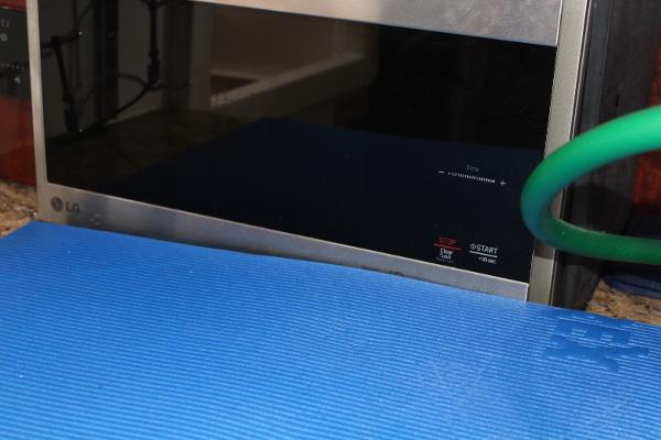 Slide: The Image of LG microwave oven with a blue mat in the foreground. - 44