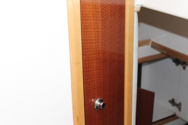 Slide: The Image of Wooden cabinet door with metal knob inside a 2008 Contender 38 Express boat. - 45