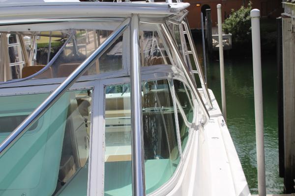 Slide: The Image of 2008 Contender 38 Express boat docked, side view with clear windows and sleek design. - 7