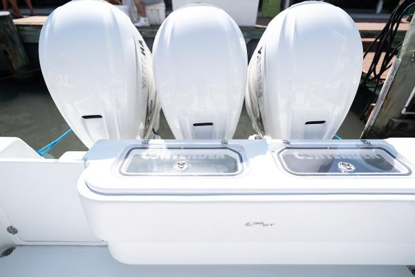 Slide: The Image of 2024 Contender 39 ST boat with triple outboard engines at dock. - 10