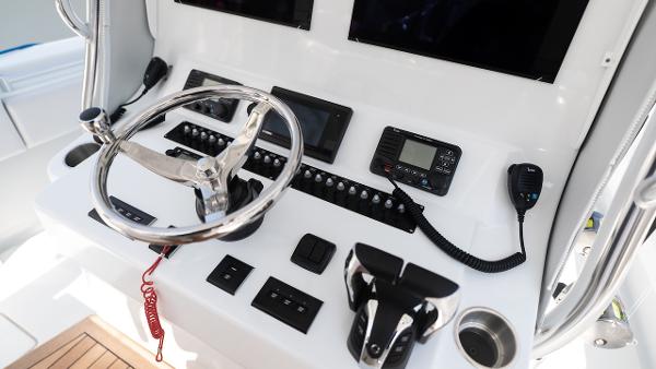 Slide: The Image of 2024 Contender 39 ST boat helm with steering wheel and control panel. - 13