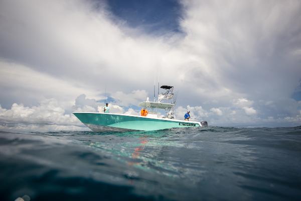 Slide: The Image of 2024 Contender 39 ST boat on open water under cloudy sky. - 2