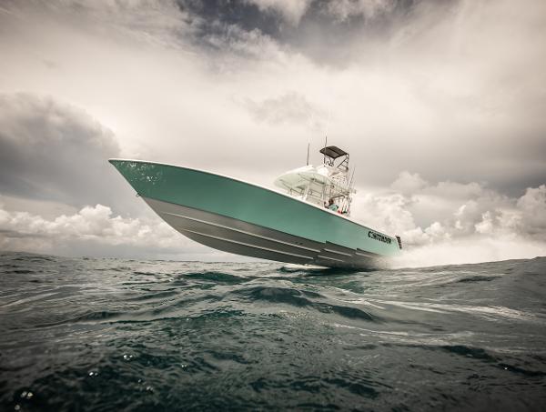 Slide: The Image of 2024 Contender 39 ST boat cruising on open water under cloudy sky. - 3