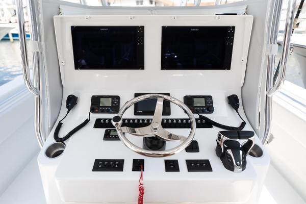 Slide: The Image of 2024 Contender 39 ST boat dashboard with dual screens and navigation controls. - 7