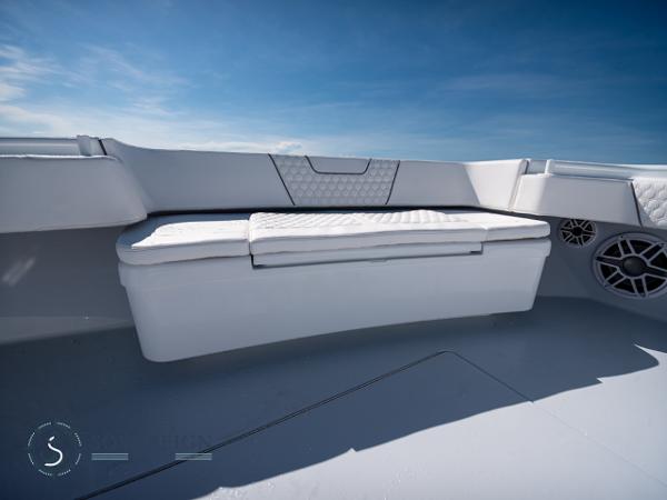 Slide: The Image of Contender 44 CB 2024 boat interior with cushioned seating and storage. - 30