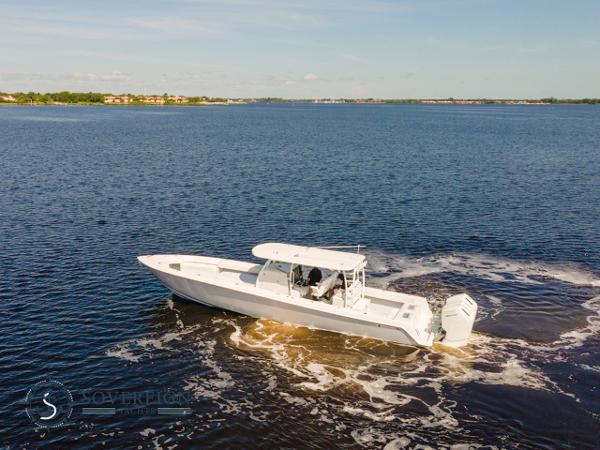 Slide: The Image of 2024 Contender 44 CB boat cruising on a calm lake. - 7