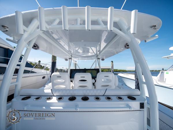 Slide: The Image of 2024 Contender 44 CB yacht with white seating and rod holders, Sovereign Yachts logo. - 8