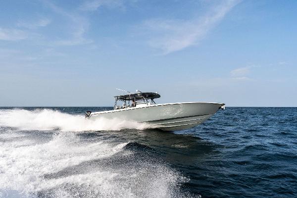 Slide: The Image of Contender 2025 44ST boat cruising on open water. - 0