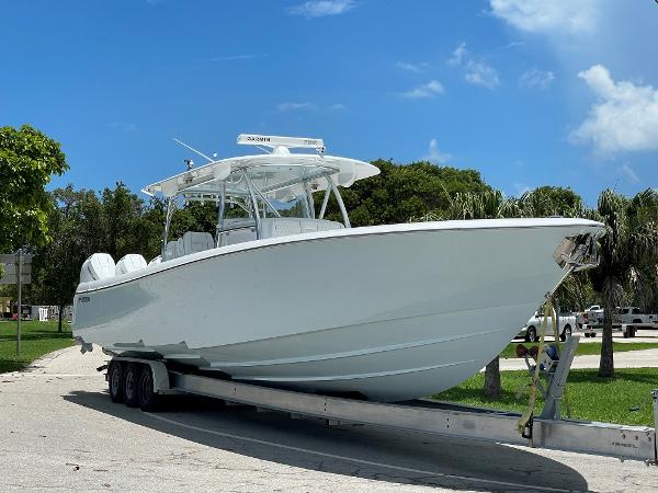 Slide: The Image of 2025 Contender 44ST boat on a trailer in a sunny outdoor setting. - 1