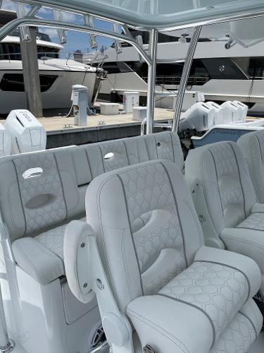 Slide: The Image of Luxurious seating on the 2025 Contender 44ST boat, docked at a marina. - 10