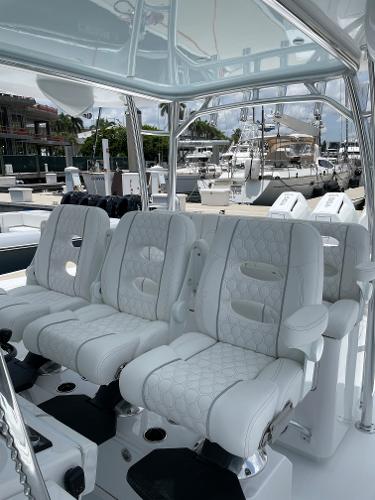 Slide: The Image of Luxurious seating on the 2025 Contender 44ST boat at a marina. - 11