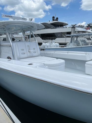Slide: The Image of 2025 Contender 44ST boat docked, showcasing sleek design and spacious seating. - 16