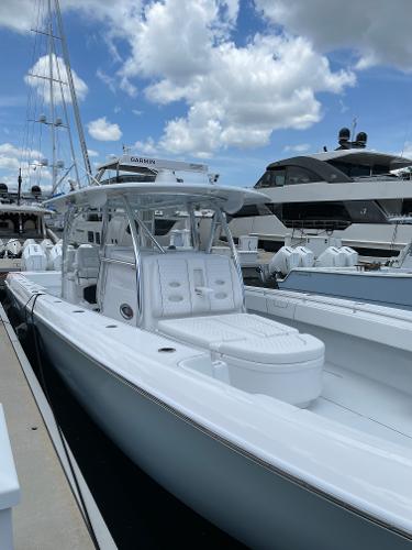 Slide: The Image of 2025 Contender 44ST boat docked at marina under blue sky. - 17