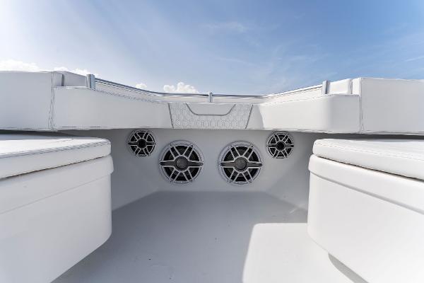 Slide: The Image of Contender 2025 44ST boat interior with speakers and seating under a clear sky. - 22