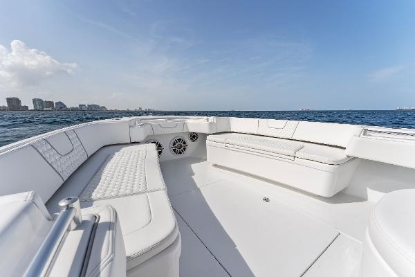 Slide: The Image of Contender 2025 44ST boat with white seating, on open water, city skyline in background. - 23
