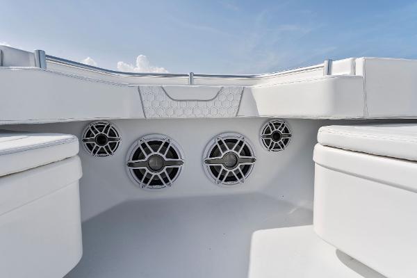 Slide: The Image of Contender 2025 44ST boat interior with built-in speakers and white seating. - 24
