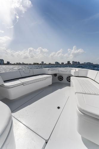 Slide: The Image of Contender 2025 44ST boat interior with white seating and ocean view. - 25