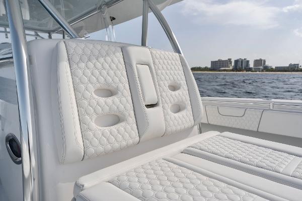 Slide: The Image of Contender 2025 44ST boat with luxurious white quilted seating, ocean backdrop. - 26
