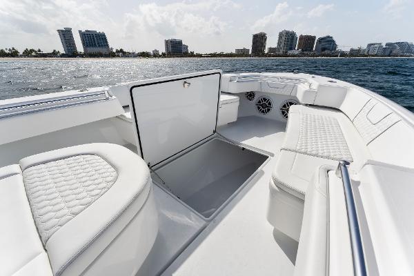 Slide: The Image of Contender 2025 44ST boat with open storage compartment and luxurious seating. - 27
