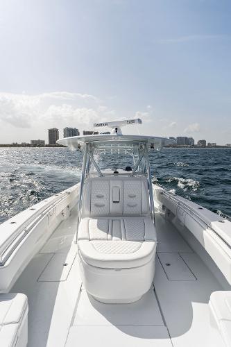 Slide: The Image of Contender 2025 44ST boat cruising on open water with city skyline in background. - 28