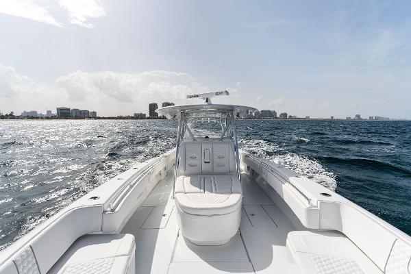 Slide: The Image of Contender 2025 44ST boat cruising on open water with city skyline in the background. - 29