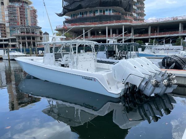Slide: The Image of 2025 Contender 44ST boat docked in marina with multiple outboard engines. - 3