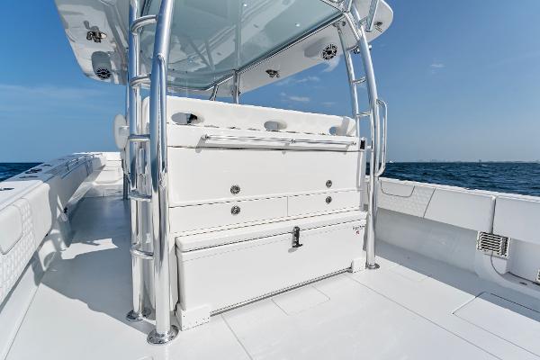 Slide: The Image of Contender 2025 44ST boat deck with storage compartments and ocean view. - 31