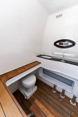 Slide: The Image of Contender 2025 44ST boat interior bathroom with wooden flooring and modern fixtures. - 42