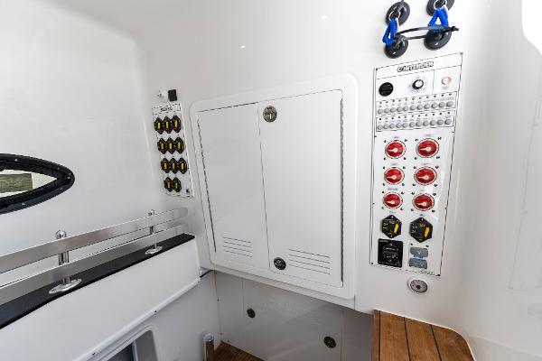 Slide: The Image of Contender 2025 44ST boat electrical panel and storage compartment. - 44