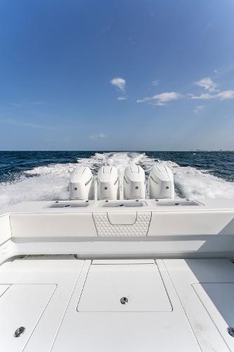 Slide: The Image of 2025 Contender 44ST boat with quad outboard engines on open water. - 45