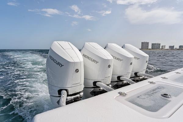 Slide: The Image of Contender 2025 44ST boat with four Mercury outboard engines cruising on the ocean. - 46