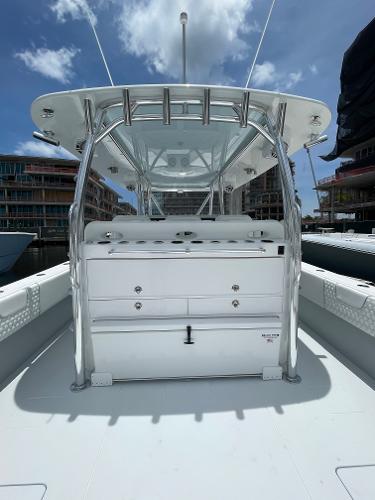 Slide: The Image of 2025 Contender 44ST boat with center console and modern design docked at marina. - 7