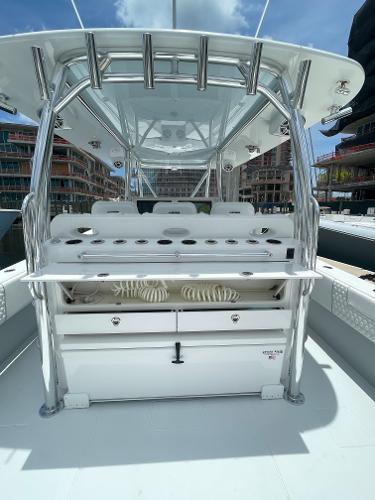 Slide: The Image of Contender 2025 44ST boat with modern helm station and rod holders, docked in a marina. - 8