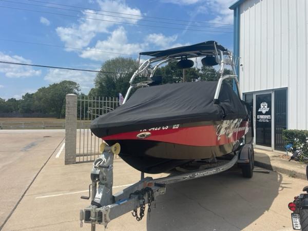 Slide: The Image of 2008 Correct Craft 220 TE boat on trailer, covered, parked outside a building. - 1