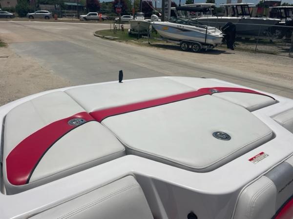 Slide: The Image of 2008 Correct Craft 220 TE boat with white and red upholstery, docked at a marina. - 3