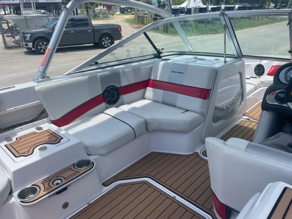Slide: The Image of 2008 Correct Craft 220 TE interior with white and red seating, wood accents, and cup holders. - 5