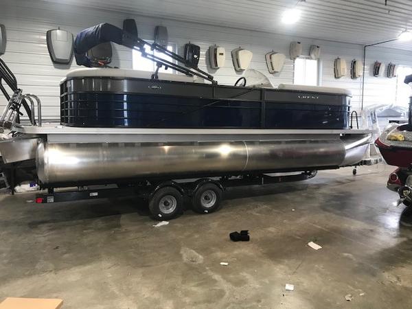 Slide: The Image of 2018 Crest II 230 SLC pontoon boat in indoor storage on a trailer. - 1