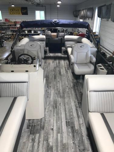 Slide: The Image of 2018 Crest II 230 SLC pontoon boat interior with gray flooring and white seating. - 2