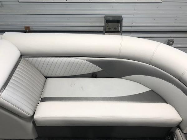 Slide: The Image of 2018 Crest II 230 SLC boat interior with white and gray cushioned seating. - 4