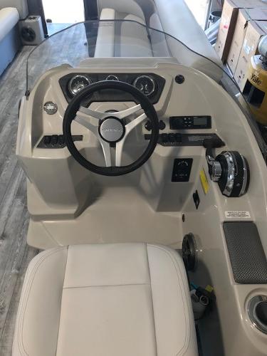 Slide: The Image of 2018 Crest II 230 SLC boat dashboard with steering wheel and controls. - 8