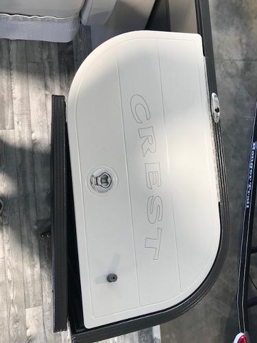 Slide: The Image of 2018 Crest II 230 SLC boat compartment with embossed logo and lock. - 9