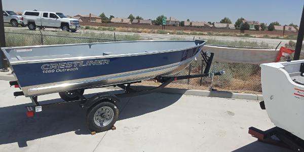 Slide: The Image of 2023 Crestliner 1469 Outreach boat on trailer in outdoor setting. - 1