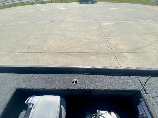 Slide: The Image of 2023 Crestliner 1600 Storm boat interior with gray seating and storage compartments. - 18